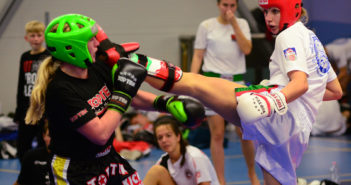 Kick-light competition during a kickboxing tournament in Prague where a Slovakian woman attacks her Austrian opponent with an axe kick.